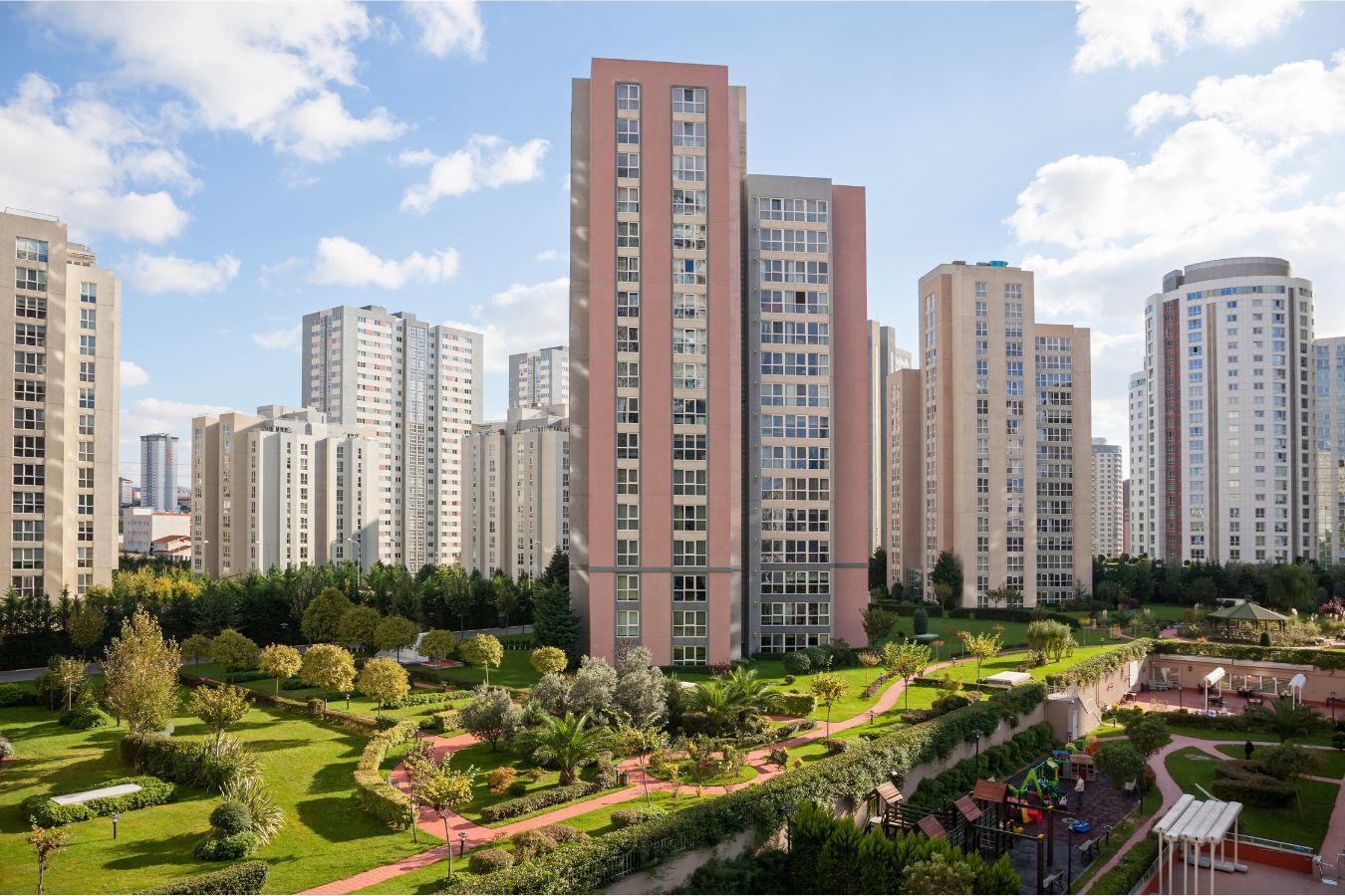 Group of tall building with open spaces and meadows